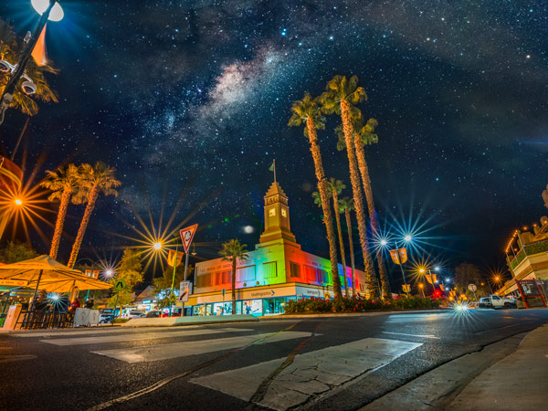 a colourful and brightly lit installation underneath a starry night