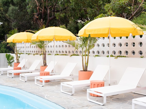 sun loungers with yellow umbrellas in the pool at Sunnymead