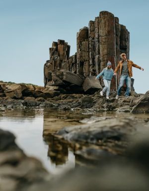 A couple explores Bombo Quarry on the Sapphire Coast, NSW