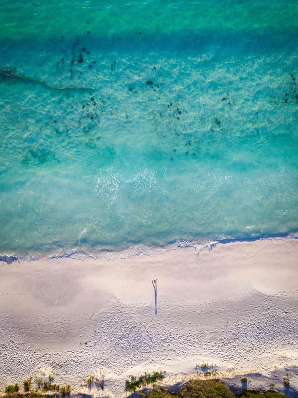 Aerial shot of someone walking on Hyams Beach in NSW