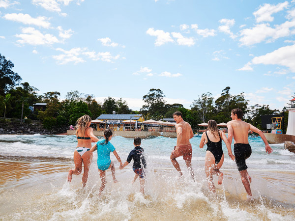 a family running through the water at Jamberoo Action Park