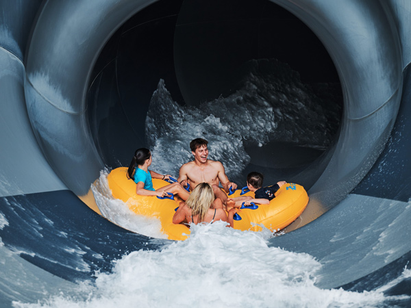 a family dropping into the funnel web slide at Jambaroo action park