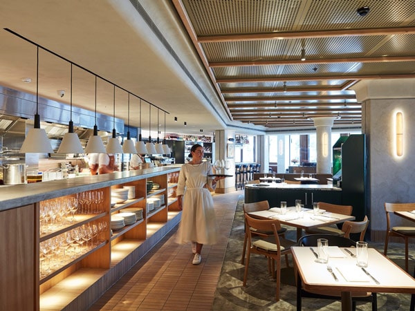 a waitress walking with a tray in hand at Margaret