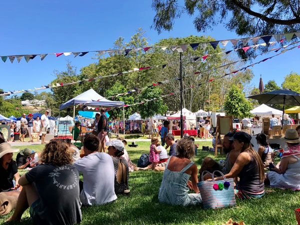 people having a picnic on the grounds of Murwillumbah Makers and Finders Markets