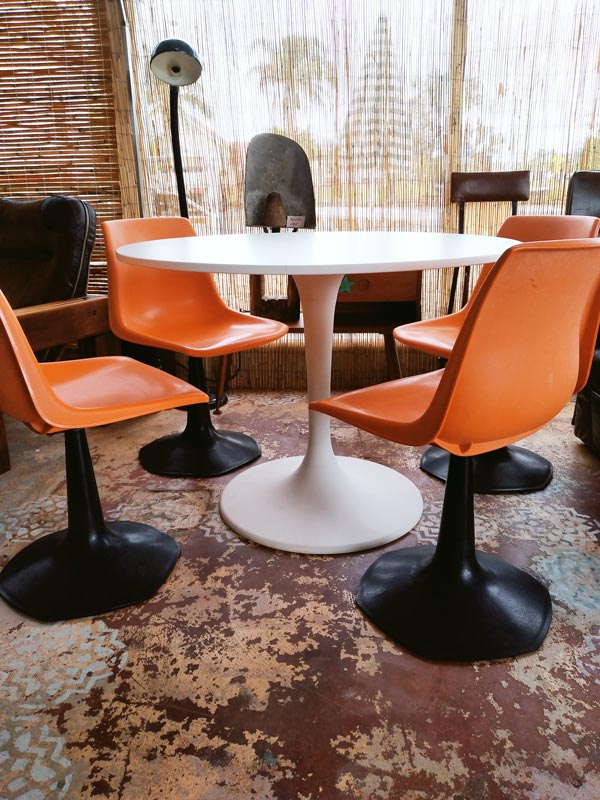 Table with Orange chairs at Oscar & Keane Eco Vintage Furniture in Byron Bay