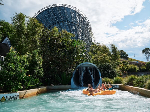 a group of people sliding down the Perfect Storm ride