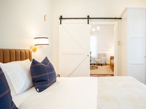 a white-painted bedroom in Ampersand Estates