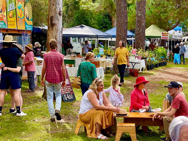 people shopping and dining at The Channon Craft Market, Byron Bay
