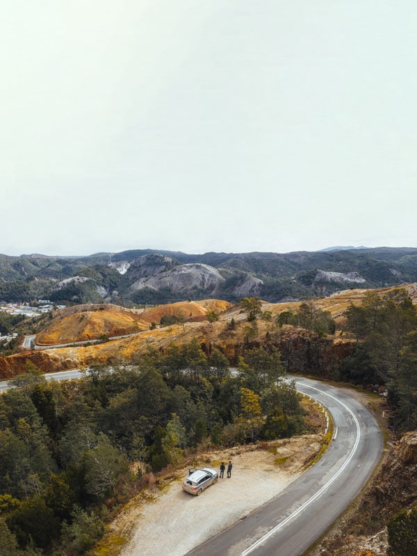 a car driving along Queenstown on the road of 99 bends