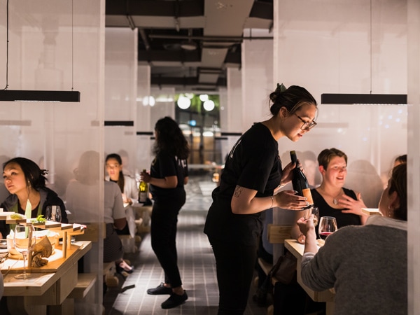 waiters serving guests at INARI