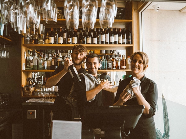 Blue Manna staff smiling in front of the camera