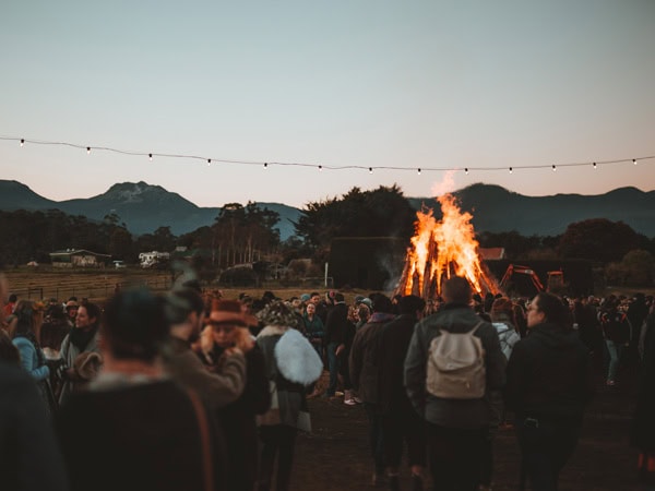 A crowd gathers around a fire at the Huon Valley Mid-Winter Festival at Willie Smith's cidery