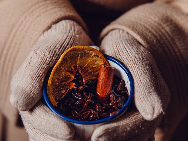 a hand holding a mug of mulled wine from The Haus Hahndorf