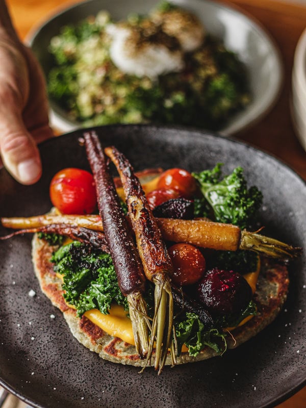 The Sweet Potato Flatbread made with purple kumara flatbread, pumpkin and confit garlic puree, roasted heirloom Dutch carrots, kale and cherry tomatoes from Bayleaf Byron Bay