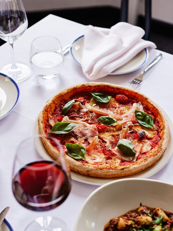pizza and wine on the table at The Gertrude Hotel, Melbourne, Vic
