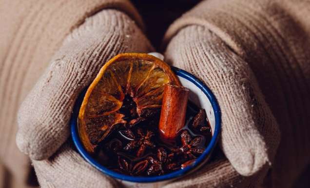 a hand holding a mug of mulled wine from The Haus Hahndorf