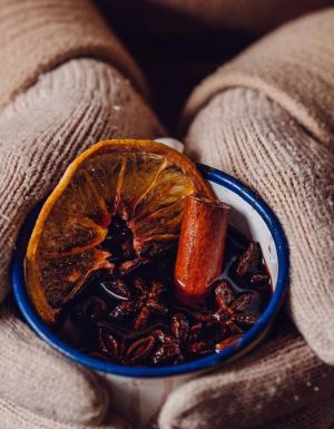 a hand holding a mug of mulled wine from The Haus Hahndorf