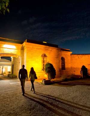 two people entering Old Mount Gambier Gaol at night
