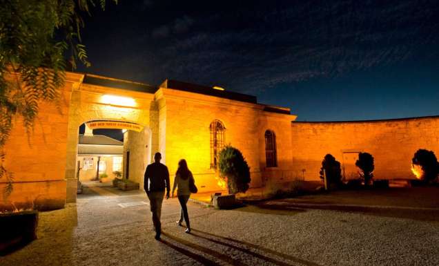 two people entering Old Mount Gambier Gaol at night