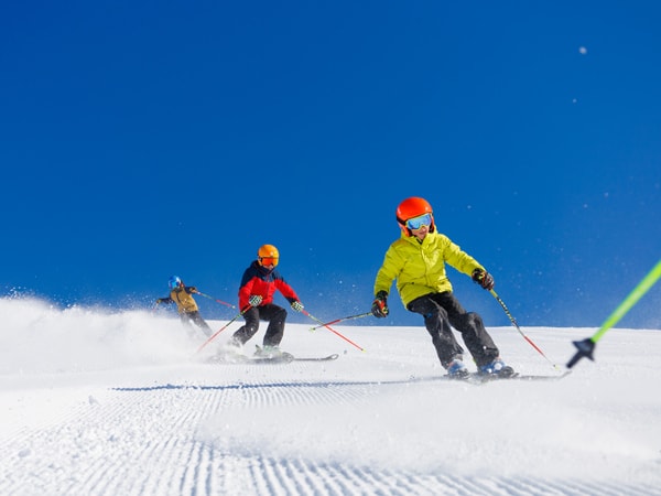 Kids skiing down the slopes at Thredbo