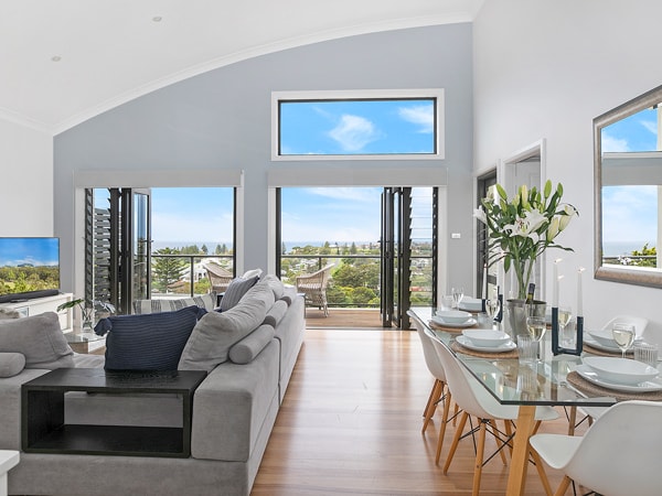 a modern room interior with scenic views from the balcony at La Terrasse, Kiama