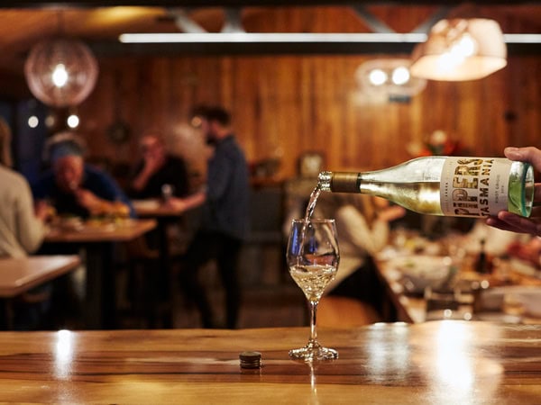pouring a drink into the glass at River Run Lodge, Strathblane, Tas