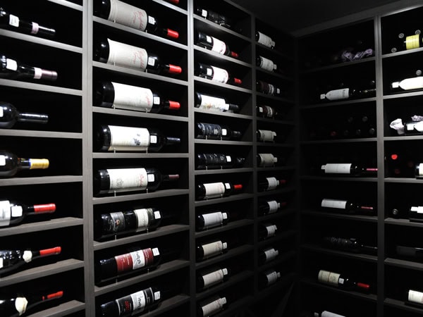 a stack of wine bottles in the storage of The Barn Steakhouse