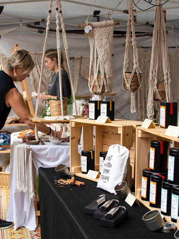 a woman browsing products at a stall in Original Eumundi Markets, Eumundi