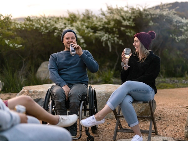 guests with disabilities drinking at Little Beach Co Glamping