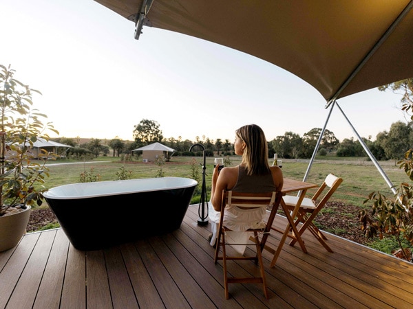a woman relaxing on the deck of a CABN X in the Barossa Valley