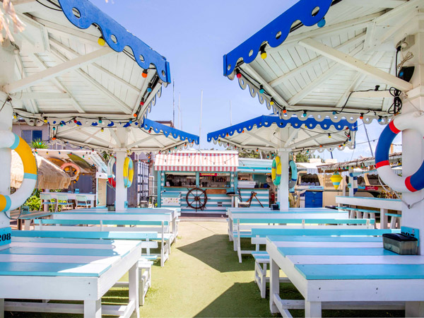 alfresco dining with blue umbrellas and tables at Cook at Kurnell
