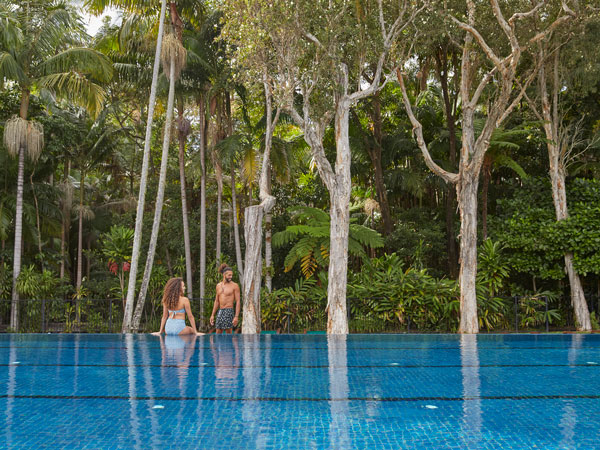 a couple relaxing by the pool at Crystalbrook Byron