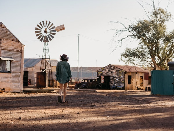 a woman exploring Gwalia Ghost Town