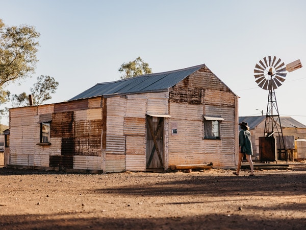 a woman exploring the abandoned gold mining town of Gwalia, WA