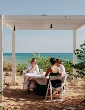 friends dining on the beachfront of Eco Beach Resort