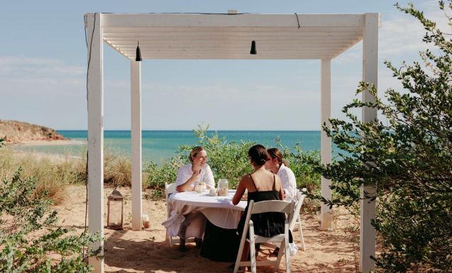 friends dining on the beachfront of Eco Beach Resort