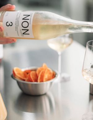 pouring NON 3 drink into a glass