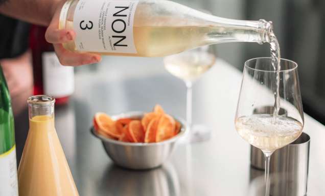 pouring NON 3 drink into a glass