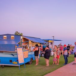 people lining up outside a food stall at Town Beach Night Markets, Broome