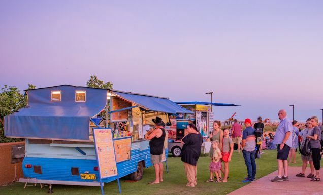 people lining up outside a food stall at Town Beach Night Markets, Broome