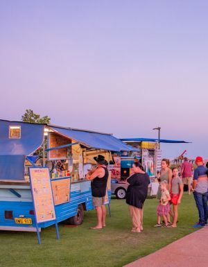 people lining up outside a food stall at Town Beach Night Markets, Broome