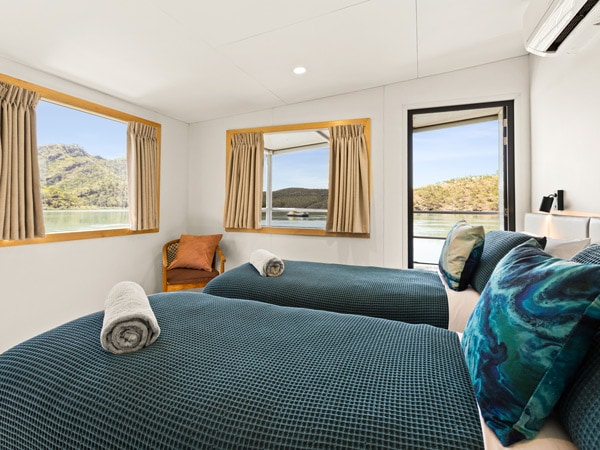 a bed facing windows with waterfront views in Horizontal Falls Accommodation at Jet Wave Pearl