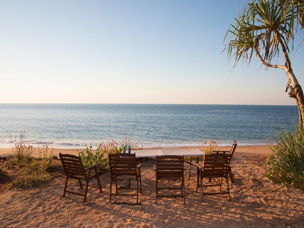 a beachfront dining setup at Mercedes Cove Exclusive Coastal Retreat