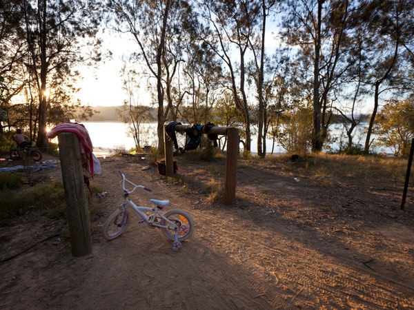 a kid's bicycle parked near the river on Red Gum Campground