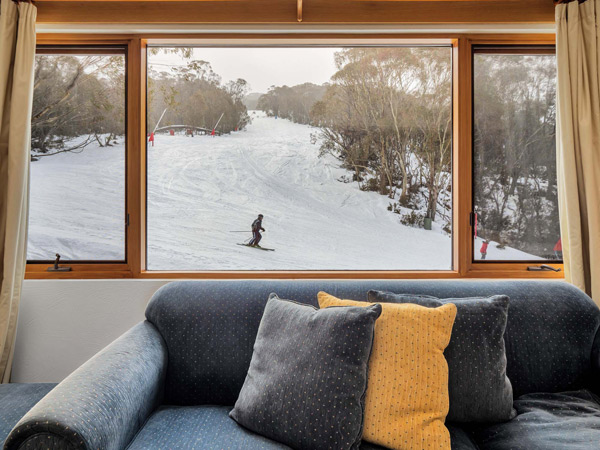 a man skiing out the window at Ski In Ski Out, Thredbo accommodation