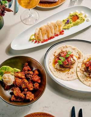 A table topped with plates of food and drinks.