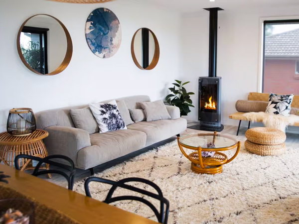 a living room with a fireplace at The Werri Shack, Kiama accommodation