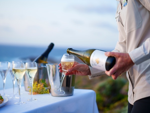 Wine is poured for guests on Cape To Cape Walk with Walk Into Luxury