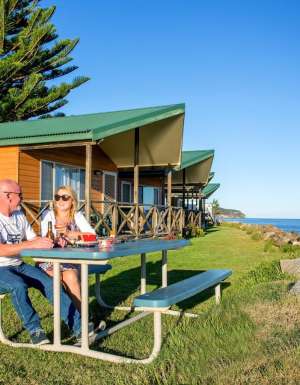 a couple al fresco dining at BIG4 Batemans Bay at East's Riverside Holiday Park