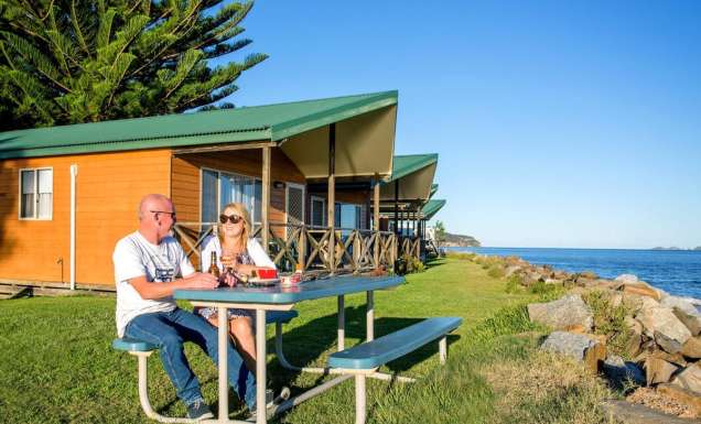a couple al fresco dining at BIG4 Batemans Bay at East's Riverside Holiday Park